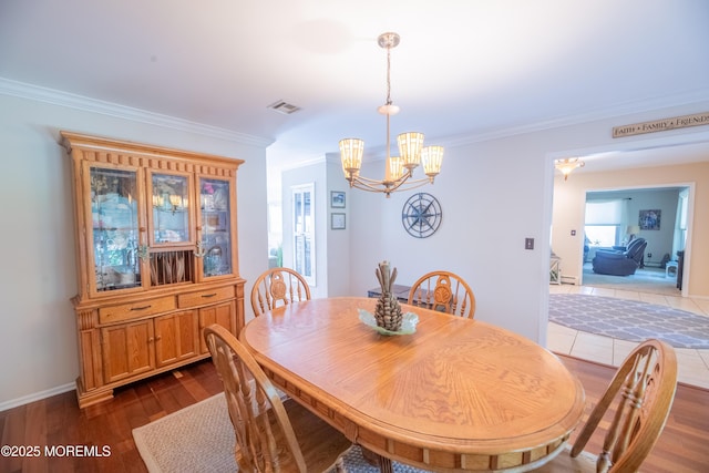 1920 Kenilworth Ct, Toms River, NJ 08753 - dining area featuring a chandelier, ornamental molding, and dark wood-style floors