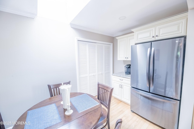 1920 Kenilworth Ct, Toms River, NJ 08753 - kitchen with freestanding refrigerator, light wood-style flooring, crown molding, white cabinets, and light stone counters