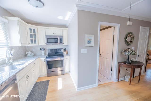 1920 Kenilworth Ct, Toms River, NJ 08753 - kitchen featuring appliances with stainless steel finishes, light stone countertops, ornamental molding, tasteful backsplash, and glass insert cabinets
