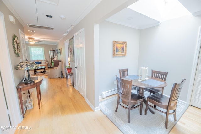 1920 Kenilworth Ct, Toms River, NJ 08753 - dining area with light wood finished floors, a baseboard radiator, ornamental molding, and attic access