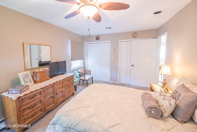 1920 Kenilworth Ct, Toms River, NJ 08753 - bedroom with two closets, light colored carpet, ceiling fan, and baseboard heating
