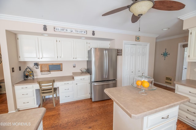 1920 Kenilworth Ct, Toms River, NJ 08753 - kitchen with freestanding refrigerator, built in study area, crown molding, a ceiling fan, and white cabinetry