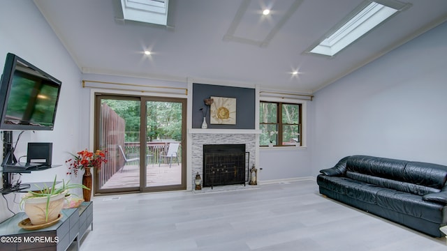 57 Chestnut Way, Manalapan, NJ 07726 - living area with vaulted ceiling, plenty of natural light, wood finished floors, a fireplace with flush hearth, and a skylight