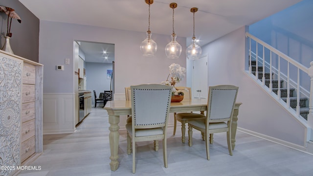 57 Chestnut Way, Manalapan, NJ 07726 - dining space featuring light wood-style flooring, stairs, and wainscoting