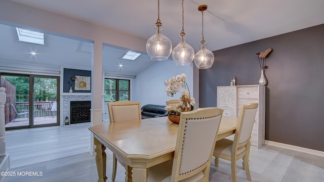 57 Chestnut Way, Manalapan, NJ 07726 - dining space featuring a skylight, healthy amount of natural light, a fireplace, and light wood-style floors