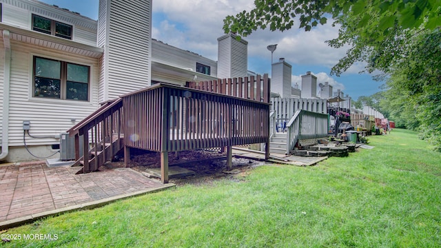 57 Chestnut Way, Manalapan, NJ 07726 - rear view of property featuring stairway, a lawn, a deck, a patio area, and a chimney
