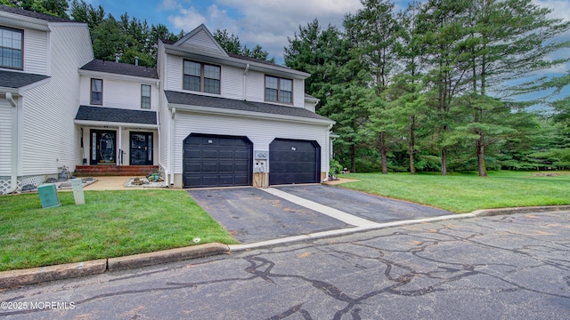 57 Chestnut Way, Manalapan, NJ 07726 - traditional home featuring driveway, a garage, a front lawn, and view of wooded area
