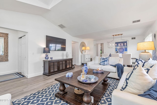 2254 S Chanticleer Ct, Toms River, NJ 08755 - living room featuring wood finished floors, lofted ceiling, and a chandelier