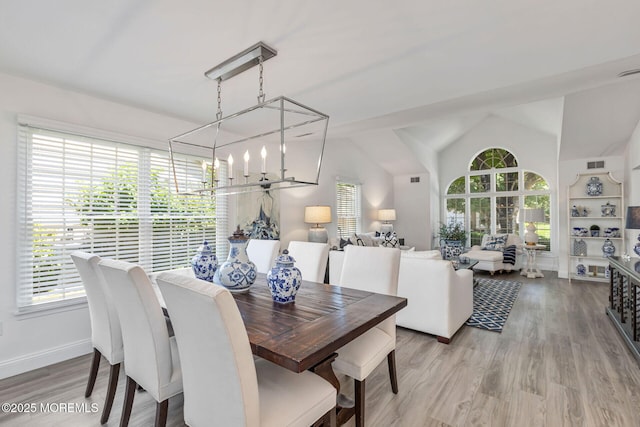 2254 S Chanticleer Ct, Toms River, NJ 08755 - dining room featuring a chandelier, wood finished floors, and lofted ceiling