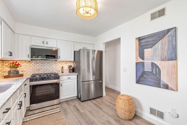 2254 S Chanticleer Ct, Toms River, NJ 08755 - kitchen featuring stainless steel appliances, white cabinets, backsplash, and light wood-style floors