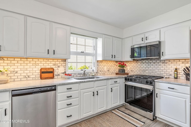 2254 S Chanticleer Ct, Toms River, NJ 08755 - kitchen featuring stainless steel appliances, white cabinetry, tasteful backsplash, and light stone countertops