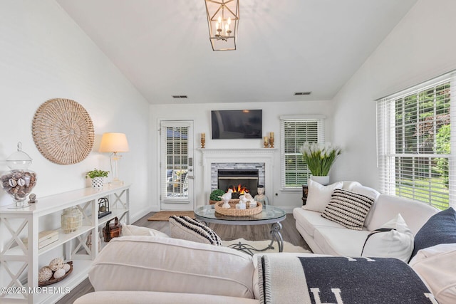 2254 S Chanticleer Ct, Toms River, NJ 08755 - living room featuring vaulted ceiling, wood finished floors, a high end fireplace, and a chandelier