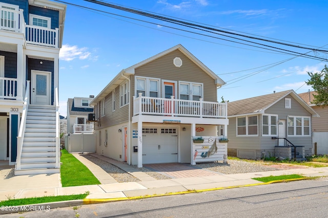 307 Webster Ave, Seaside Heights, NJ 08751 - view of front of property with stairs, an attached garage, driveway, and a balcony