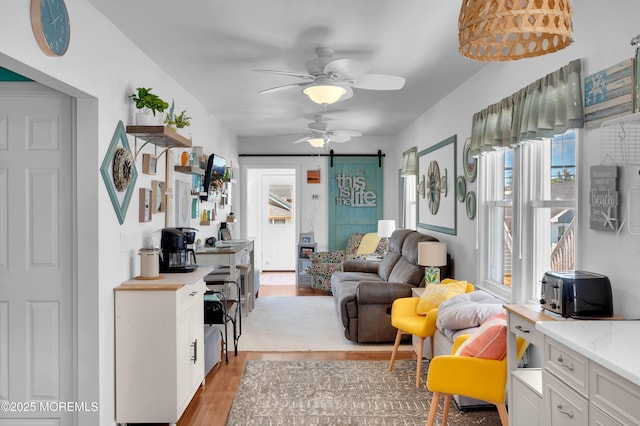 307 Webster Ave, Seaside Heights, NJ 08751 - living room with a barn door, light wood finished floors, and a ceiling fan