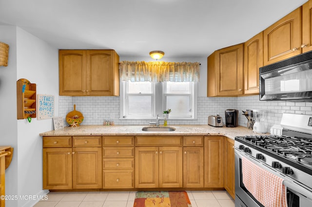 307 Webster Ave, Seaside Heights, NJ 08751 - kitchen with stainless steel gas range oven, black microwave, light stone counters, and decorative backsplash