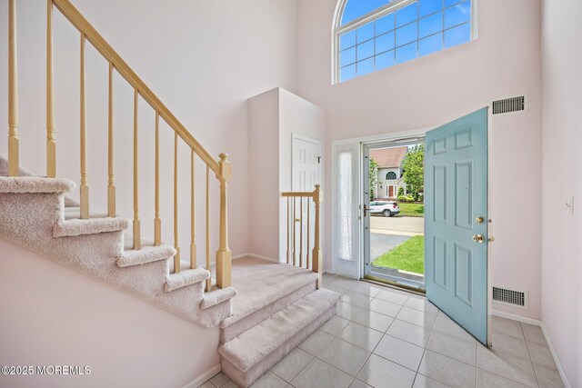 57 High Pointe Way, Matawan, NJ 07747 - foyer with a towering ceiling, stairs, and tile patterned flooring