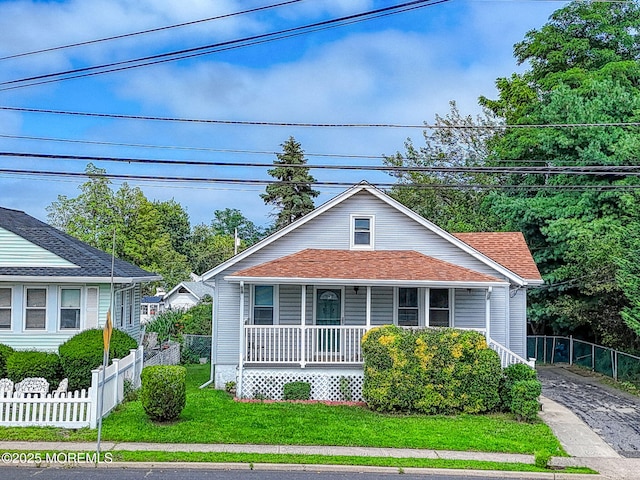198 W Sylvania Ave, Neptune City, NJ 07753 - bungalow featuring a porch, driveway, and a shingled roof