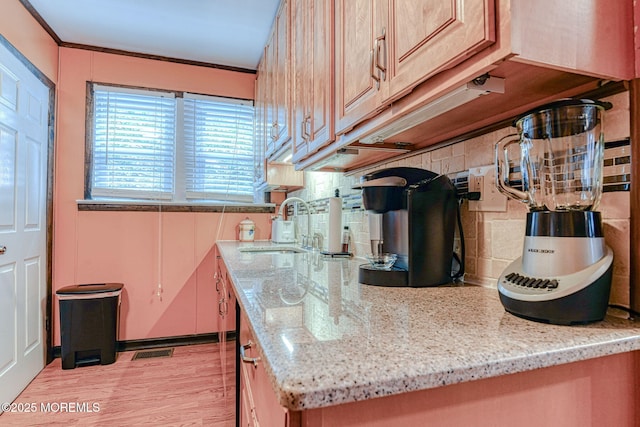 198 W Sylvania Ave, Neptune City, NJ 07753 - kitchen featuring tasteful backsplash, light wood-style floors, and light stone countertops