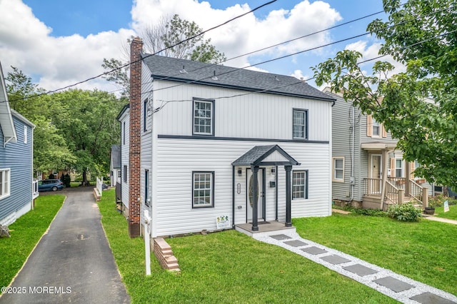 101 Broad St, Matawan, NJ 07747 - traditional home featuring roof with shingles, a chimney, a front lawn, and driveway