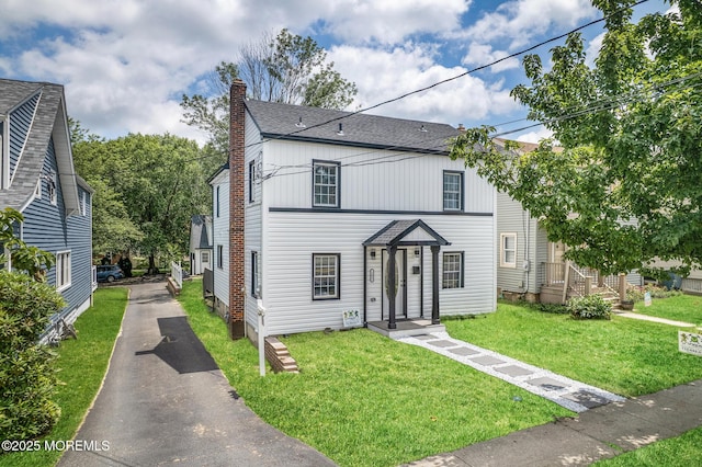 101 Broad St, Matawan, NJ 07747 - view of front of property featuring a chimney, driveway, a front lawn, and a shingled roof