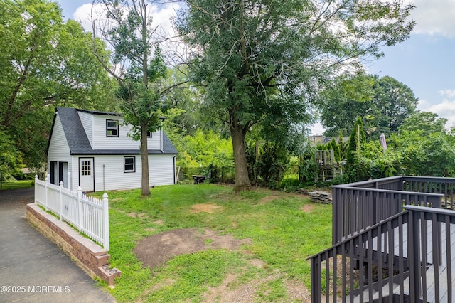 101 Broad St, Matawan, NJ 07747 - view of grassy yard with a deck and view of wooded area
