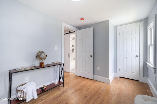 101 Broad St, Matawan, NJ 07747 - bedroom featuring light wood-type flooring and a barn door