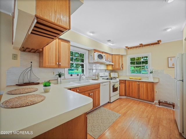 962 Columbus Dr, Brick, NJ 08724 - kitchen featuring white appliances, light wood-style flooring, light countertops, a peninsula, and ornamental molding