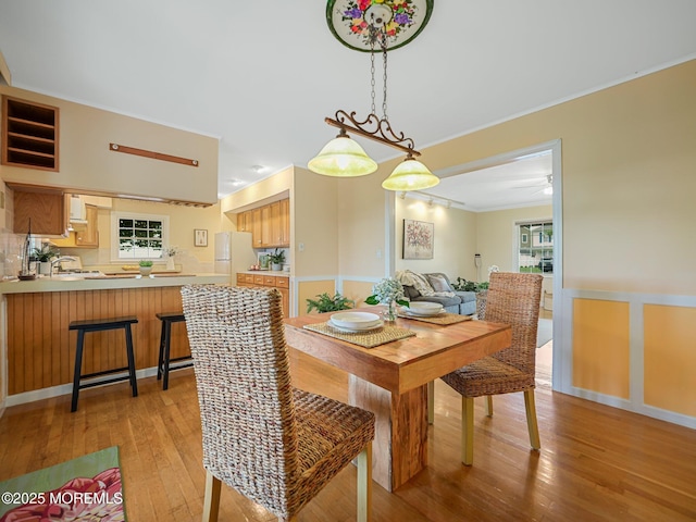 962 Columbus Dr, Brick, NJ 08724 - dining area featuring light wood-style floors, ornamental molding, and a ceiling fan