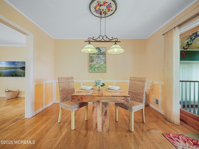 962 Columbus Dr, Brick, NJ 08724 - dining space featuring wood finished floors, wainscoting, and crown molding