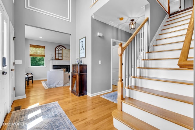 1667 Kalvel Ct, Toms River, NJ 08755 - foyer with stairs, wood finished floors, a fireplace, and a towering ceiling