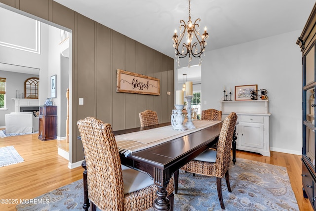 1667 Kalvel Ct, Toms River, NJ 08755 - dining space featuring light wood-style flooring, a chandelier, and a fireplace