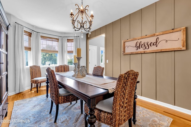1667 Kalvel Ct, Toms River, NJ 08755 - dining area with a chandelier, light wood-style flooring, and a decorative wall