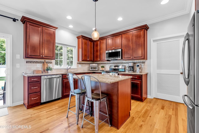 1667 Kalvel Ct, Toms River, NJ 08755 - kitchen featuring appliances with stainless steel finishes, ornamental molding, light wood finished floors, decorative light fixtures, and tasteful backsplash