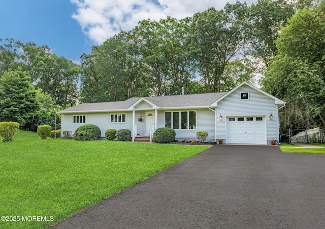 10 Locust Grove Ln, Manalapan, NJ 07726 - ranch-style house with an attached garage, asphalt driveway, a shingled roof, and view of scattered trees