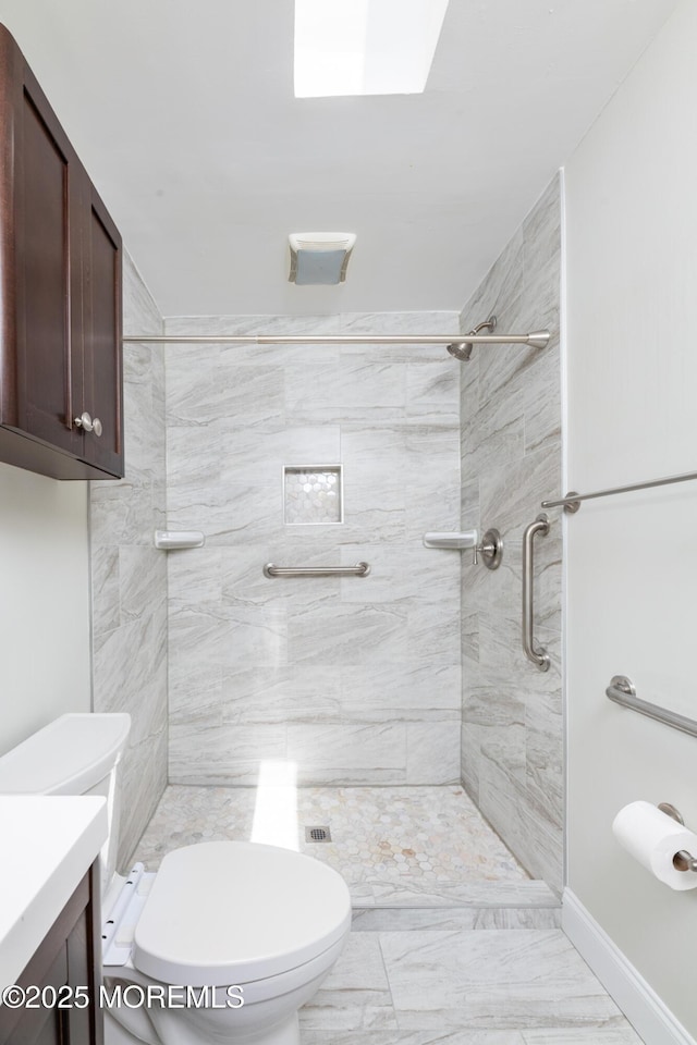 10 Locust Grove Ln, Manalapan, NJ 07726 - bathroom featuring vanity, tiled shower, a skylight, and marble look tile flooring