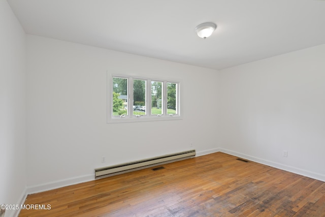 10 Locust Grove Ln, Manalapan, NJ 07726 - spare room with a baseboard heating unit and hardwood / wood-style floors