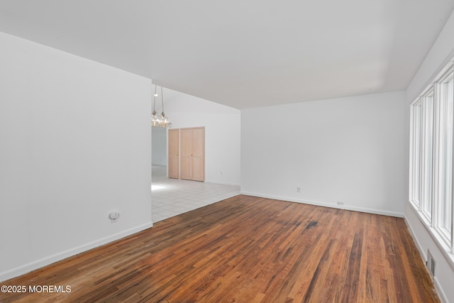 10 Locust Grove Ln, Manalapan, NJ 07726 - unfurnished room with a chandelier, hardwood / wood-style floors, and vaulted ceiling