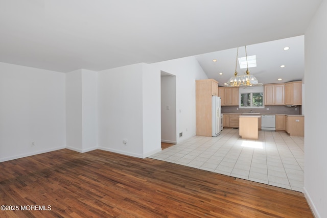 10 Locust Grove Ln, Manalapan, NJ 07726 - kitchen with white appliances, light brown cabinetry, open floor plan, a chandelier, and recessed lighting