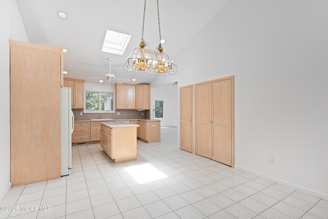 10 Locust Grove Ln, Manalapan, NJ 07726 - kitchen featuring light brown cabinets, a skylight, freestanding refrigerator, light countertops, and a kitchen island
