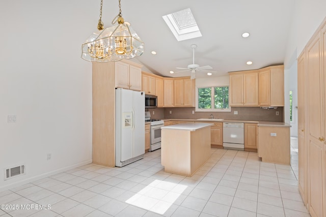 10 Locust Grove Ln, Manalapan, NJ 07726 - kitchen with white appliances, light brown cabinetry, a skylight, light countertops, and recessed lighting