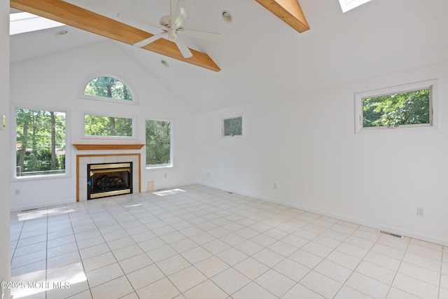 10 Locust Grove Ln, Manalapan, NJ 07726 - unfurnished living room featuring high vaulted ceiling, beam ceiling, plenty of natural light, a tiled fireplace, and ceiling fan