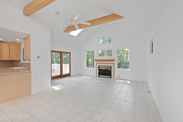 10 Locust Grove Ln, Manalapan, NJ 07726 - unfurnished living room featuring a skylight, high vaulted ceiling, beam ceiling, a ceiling fan, and a tiled fireplace