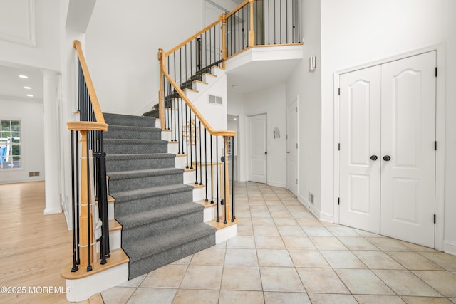 95 Linden Ave, West Long Branch, NJ 07764 - stairs with a towering ceiling, decorative columns, recessed lighting, and tile patterned flooring