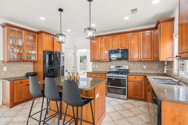 95 Linden Ave, West Long Branch, NJ 07764 - kitchen with black appliances, decorative backsplash, a center island, brown cabinets, and recessed lighting