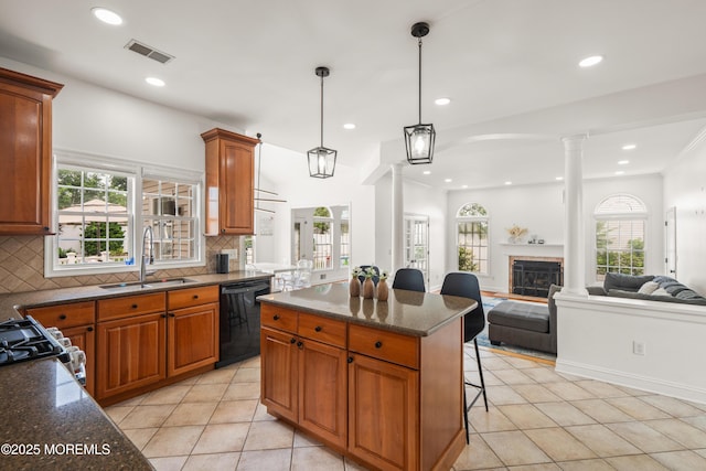 95 Linden Ave, West Long Branch, NJ 07764 - kitchen with decorative columns, black dishwasher, a fireplace, backsplash, and recessed lighting