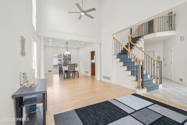 95 Linden Ave, West Long Branch, NJ 07764 - foyer with a high ceiling, a ceiling fan, stairs, wood finished floors, and ornate columns