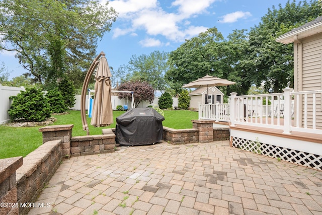 95 Linden Ave, West Long Branch, NJ 07764 - fenced backyard featuring area for grilling, a deck, a patio area, and an outbuilding