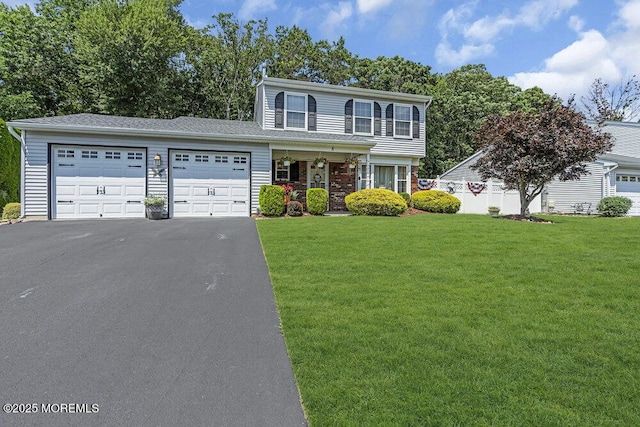 8 Yellowstone Ln, Howell, NJ 07731 - view of front of house featuring an attached garage, asphalt driveway, and a front lawn