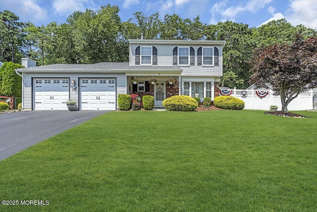 8 Yellowstone Ln, Howell, NJ 07731 - view of front facade with asphalt driveway, an attached garage, and a chimney
