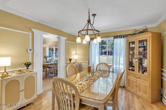 8 Yellowstone Ln, Howell, NJ 07731 - dining area featuring healthy amount of natural light, decorative columns, light wood-style floors, ornamental molding, and a chandelier